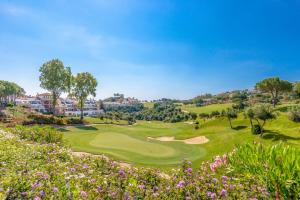 a view of a golf course with flowers at La Cala Resort in La Cala de Mijas