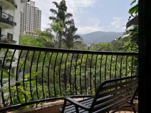 a bench sitting on a balcony with a view at GVR Homestay 3 in Genting Highlands