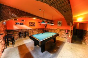 a pool table in a room with orange walls at Do Step Inn Home - Hotel & Hostel in Vienna