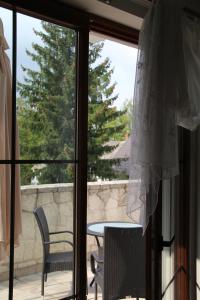 a sliding glass door with a table and chairs on a patio at Apartament Rodzinny in Kazimierz Dolny