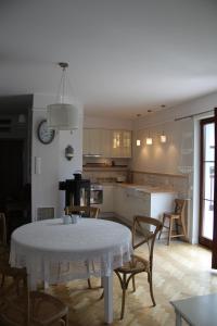 a kitchen with a table and some chairs and a table and a kitchen at Apartament Rodzinny in Kazimierz Dolny