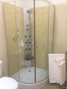 a shower with a glass door in a bathroom at Casa Amarela in Funchal