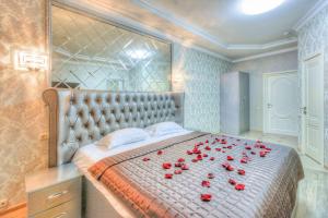 モスクワにあるKapriz Hotelのベッドルームに赤いバラのベッド