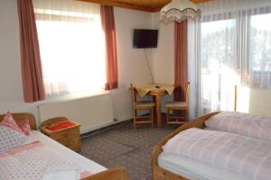 A bed or beds in a room at Innviertler Berggasthof