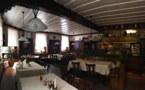 a dining room with tables and chairs in a restaurant at Schwarzwaldgasthaus Linde in Tennenbronn