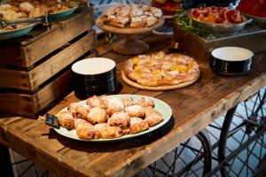 a table topped with plates of pastries and pies at Bikini Island & Mountain Port de Soller "Adults only" in Port de Soller