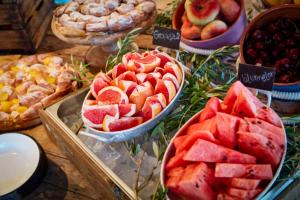 a table topped with bowls of fruit and pies at Bikini Island & Mountain Port de Soller "Adults only" in Port de Soller