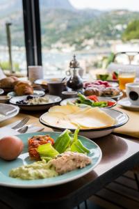 a table with plates of food on a table at Bikini Island & Mountain Port de Soller "Adults only" in Port de Soller
