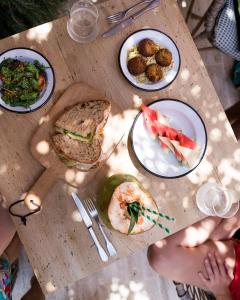 a wooden table with plates of food on it at Bikini Island & Mountain Port de Soller "Adults only" in Port de Soller