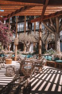 a patio with tables and chairs and a building at Bikini Island & Mountain Port de Soller "Adults only" in Port de Soller