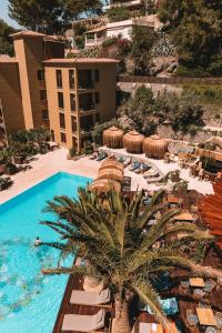 an aerial view of a resort with a pool and a palm tree at Bikini Island & Mountain Port de Soller "Adults only" in Port de Soller