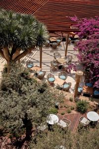 a garden with tables and chairs and plants at Bikini Island & Mountain Port de Soller "Adults only" in Port de Soller