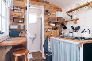 a kitchen with wooden walls and a counter with a stove at Cadleigh Manor in Ivybridge