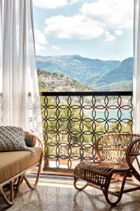 
a wooden bench sitting in front of a window at Bikini Island & Mountain Port de Soller "Adults only" in Port de Soller
