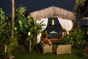 a gazebo with a lighthouse in the background at Hotel Ponta do Madeiro in Pipa