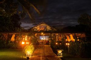a house with lights in front of it at night at Hotel Ponta do Madeiro in Pipa
