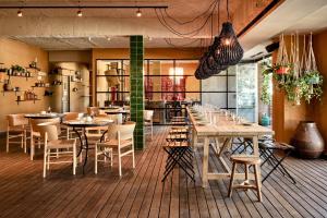 a restaurant with tables and chairs in a room at Bikini Island & Mountain Port de Soller "Adults only" in Port de Soller