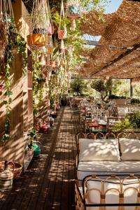 a patio with beds and tables and plants at Bikini Island & Mountain Port de Soller "Adults only" in Port de Soller