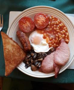 a plate of food with eggs beans bacon and toast at Lower Pinn Farm in Sidmouth
