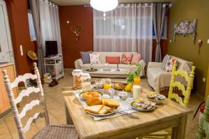 a living room with a table with food on it at Dream Catcher Artemis in Artemida