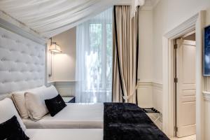 Postel nebo postele na pokoji v ubytování Hotel dei Quiriti Suite