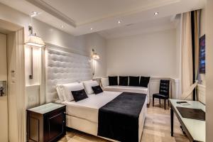 Postel nebo postele na pokoji v ubytování Hotel dei Quiriti Suite