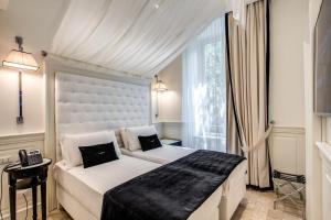 Postel nebo postele na pokoji v ubytování Hotel dei Quiriti Suite