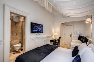 Postel nebo postele na pokoji v ubytování Hotel dei Quiriti Suite