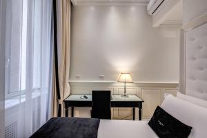 Postel nebo postele na pokoji v ubytování Hotel dei Quiriti Suite