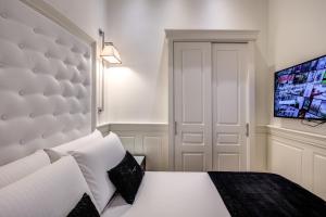 Postel nebo postele na pokoji v ubytování Hotel dei Quiriti Suite