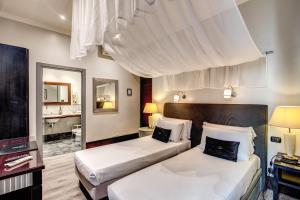 En eller flere senge i et værelse på Hotel Giuggioli