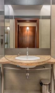 a bathroom with a sink and a mirror at Hotel-Restauracja Platan in Chrzanów