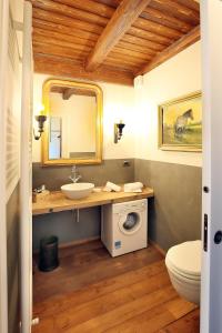 a bathroom with a sink and a washing machine at Agriturismo Malabaila in Canale