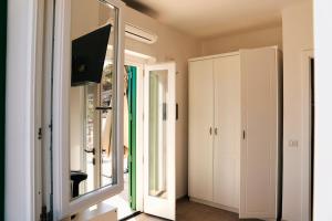 a mirror in a living room with a room with a window at Country House “ Il Mandorlo” in Acciaroli