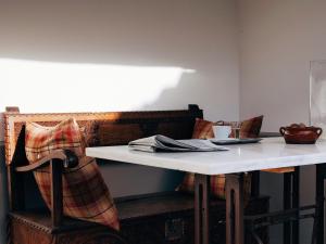 a table and a chair with a white table and a table and a table at el gran sueño Boutique Hotel & Apartamentos - Adults Only in Pintueles