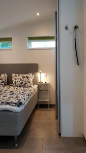a bedroom with a bed and a nightstand and a window at PAX Apartments in Lund