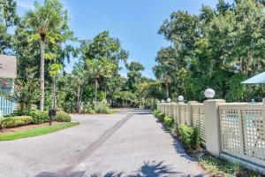 a road in a park with a fence and trees at Coral Reef Resort in Hilton Head Island
