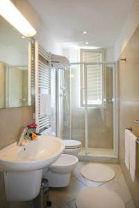 a bathroom with a sink and a toilet and a shower at Residence T2 in Rimini +55 photos