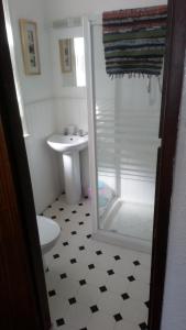 a bathroom with a shower and a toilet and a sink at MyRoomz Golden Strand Hotel in Blackpool +49 photos