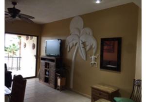 a living room with a flower mural on the wall at Sonoran Sea Resort in Puerto Peñasco