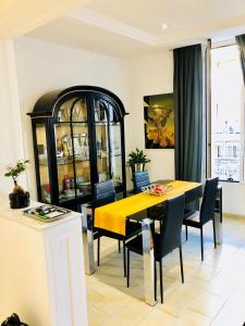 a dining room with a yellow table and chairs at Apartment 3 Pieces in Cannes