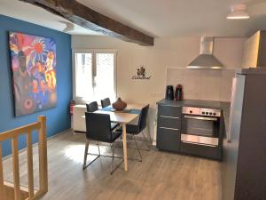 a kitchen with a table and a stove top oven at The Little Houses - Tiny Houses Malmedy - Francorchamps in Malmedy