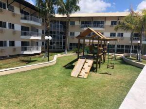 a playground in front of a building at MARUPIARA SUITES- FLAT MURO ALTO in Porto De Galinhas