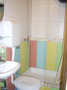a bathroom with a tub and a toilet and a sink at Apartments Villa More in Makarska
