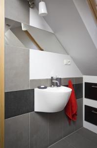 uma casa de banho com um lavatório e uma toalha vermelha em Apartament Senatorski em Kazimierz Dolny