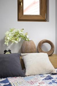 a bedroom with a bed with pillows and a mirror at Apartament Senatorski in Kazimierz Dolny