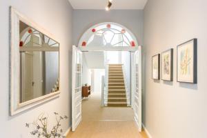 a hallway with an archway and stairs in a house at OSTKÜSTE - Nadler Hof Design Apartments in Ahlbeck