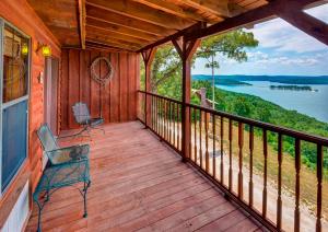 um alpendre com um banco e vista para um lago em Sugar Ridge Resort em Eureka Springs