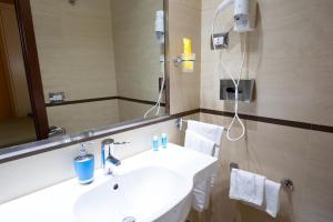 a bathroom with a white sink and a mirror at Cervara Park Hotel in Rome