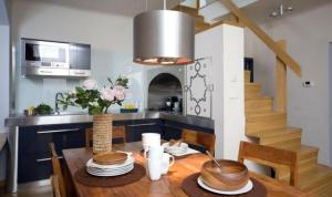 a kitchen with a wooden table and a dining room at Apartament Rynkowy in Kazimierz Dolny